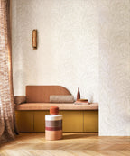 Hosta wallpaper by Casamance in ivory and gold, fine outlined foliage styled above a terracotta bench seat with a brass wall light