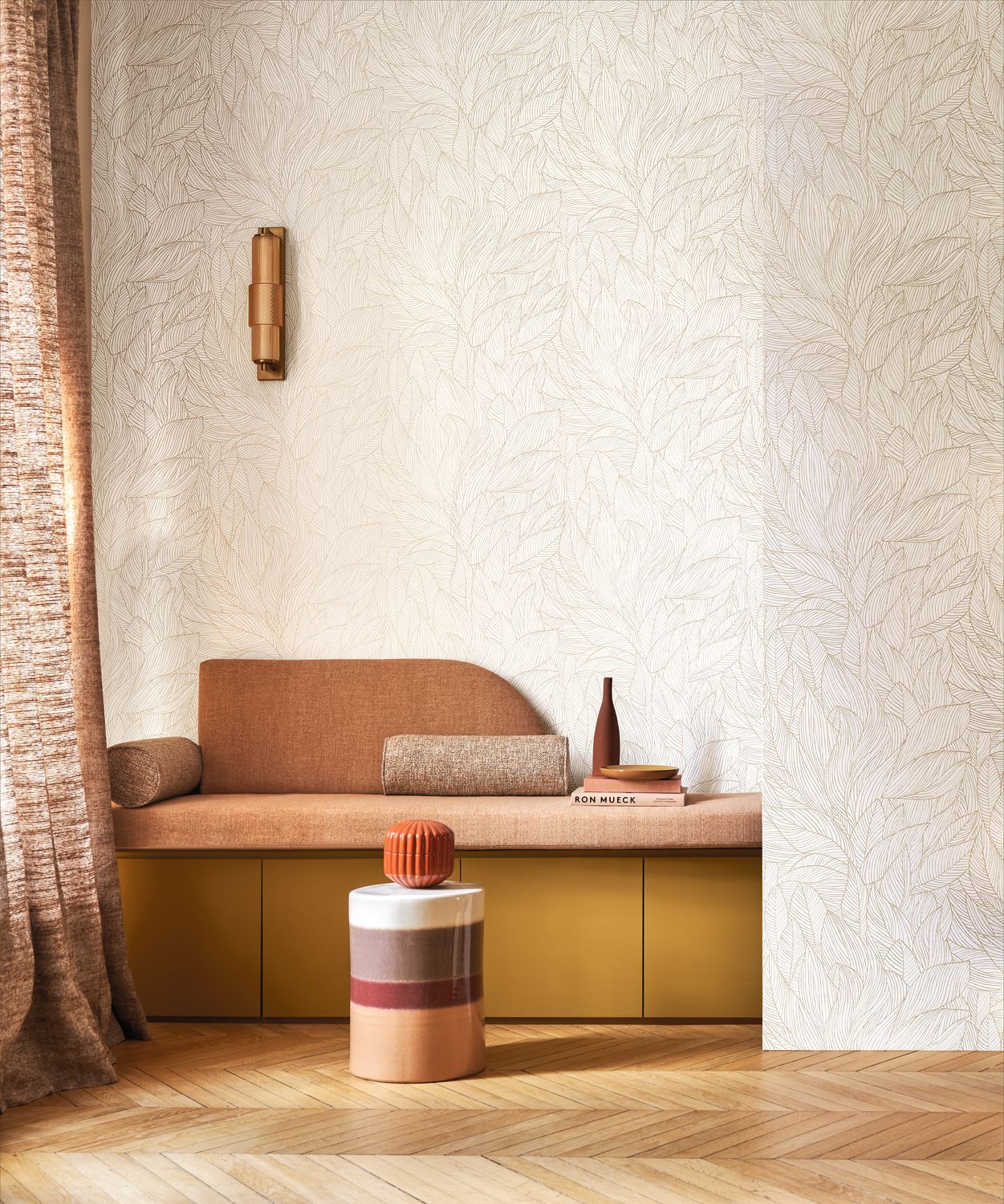 Hosta wallpaper by Casamance in ivory and gold, fine outlined foliage styled above a terracotta bench seat with a brass wall light