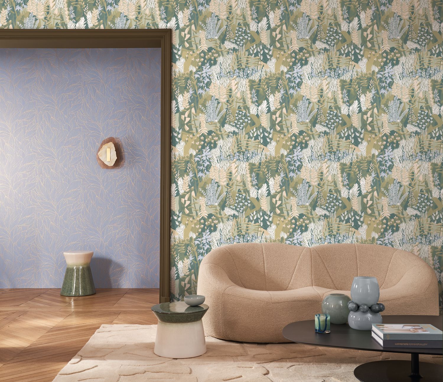 Erica wallpaper by Casamance in sage and cream, a meadow foliage print styled behind a curved boucle sofa beside a lilac wall