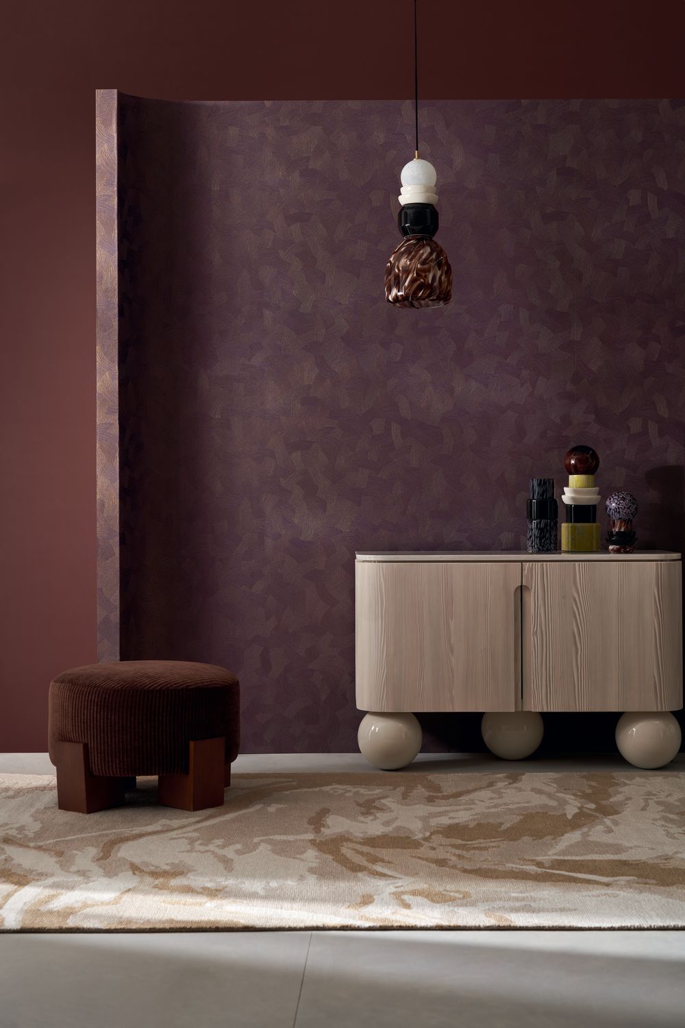 Berenice wallpaper by Casamance in plum, a tonal leaf-textured finish styled on a curved partition wall with a pale