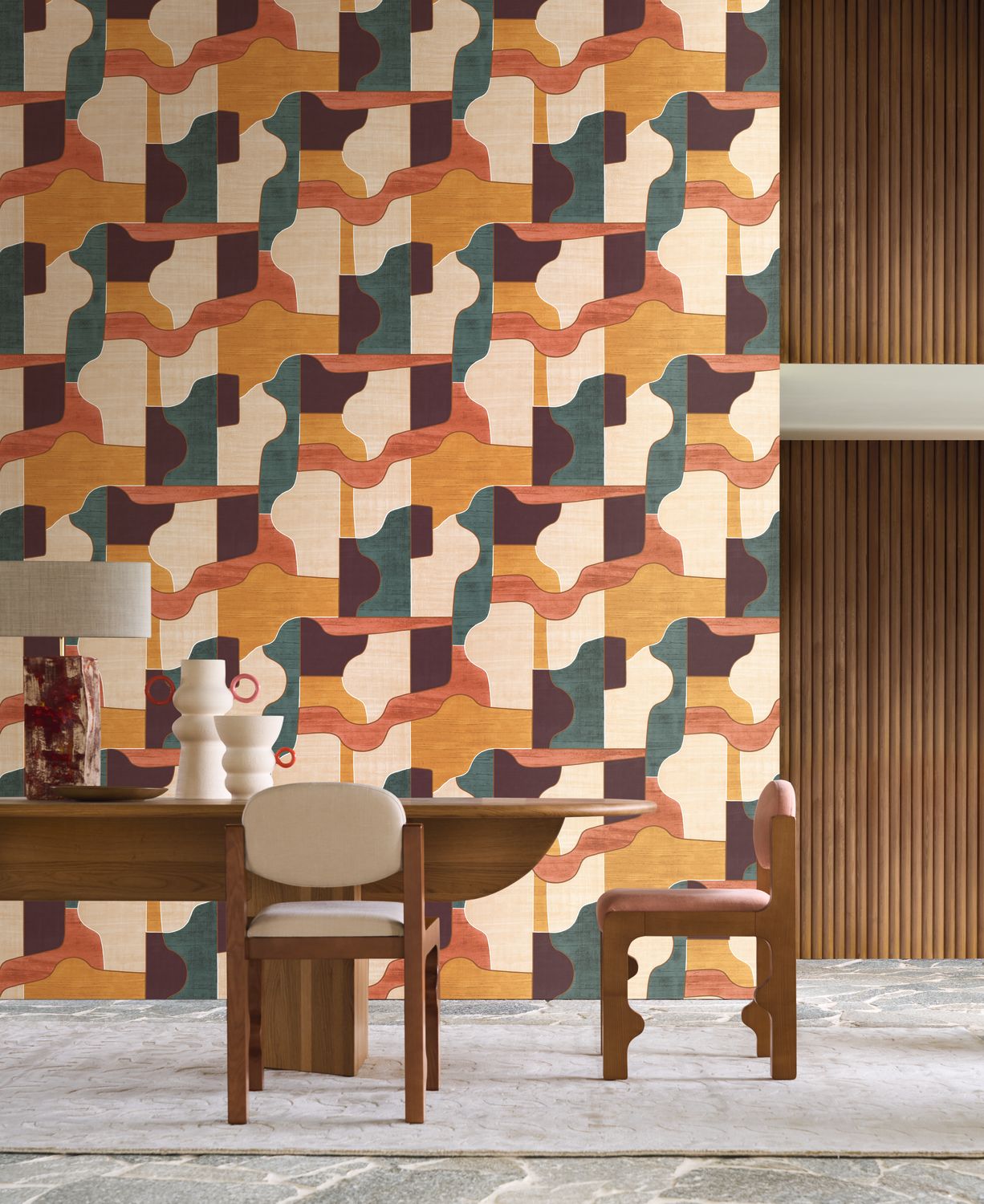 Modernismo wallpaper by Casamance in ochre, terracotta and teal, an interlocking geometric design styled in a dining room with fluted timber panelling
