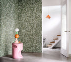 Alexander wallpaper by Casamance in olive green with fine white linework, styled in a hallway beside a pink sculptural plinth