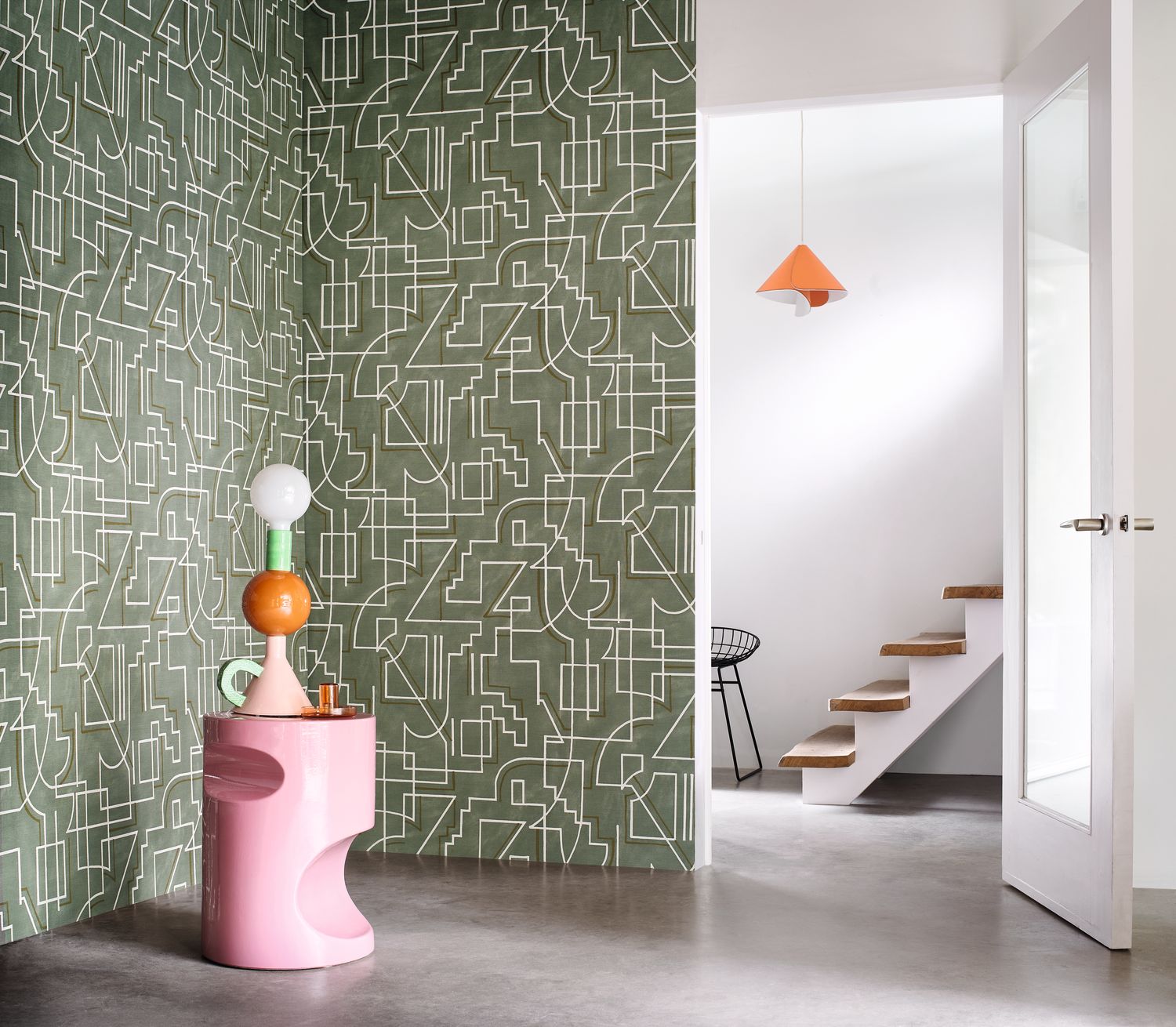 Alexander wallpaper by Casamance in olive green with fine white linework, styled in a hallway beside a pink sculptural plinth
