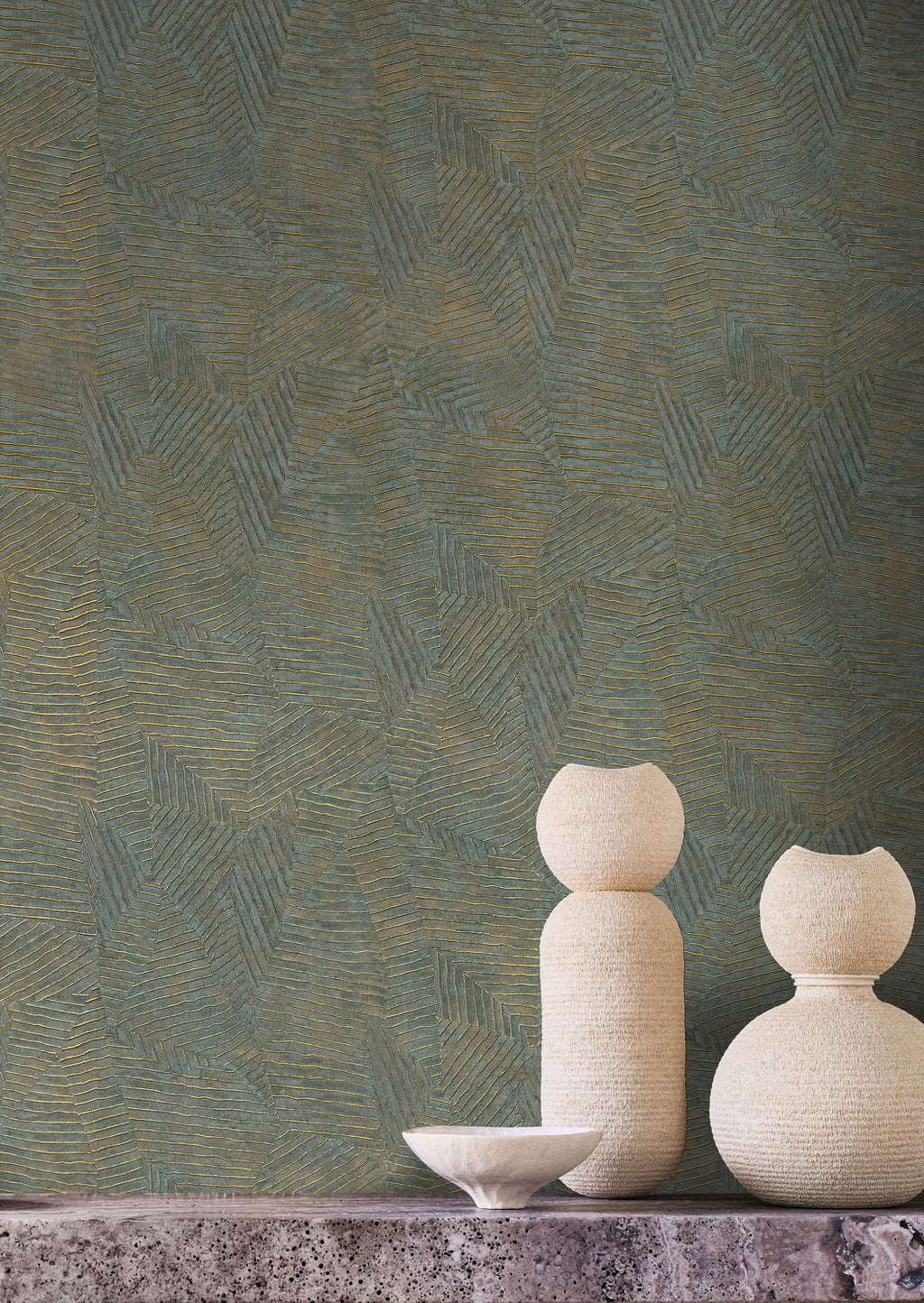 Lore wallpaper by Casamance in teal and gold, a feathered metallic texture styled behind pale sculptural vases