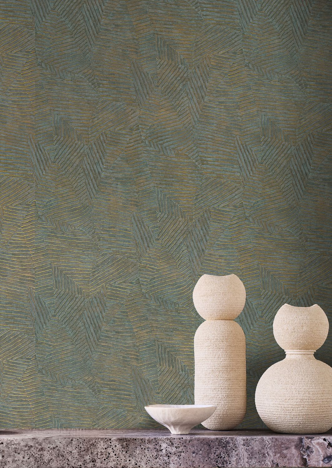 Lore wallpaper by Casamance in teal and gold, a feathered metallic texture styled behind pale sculptural vases
