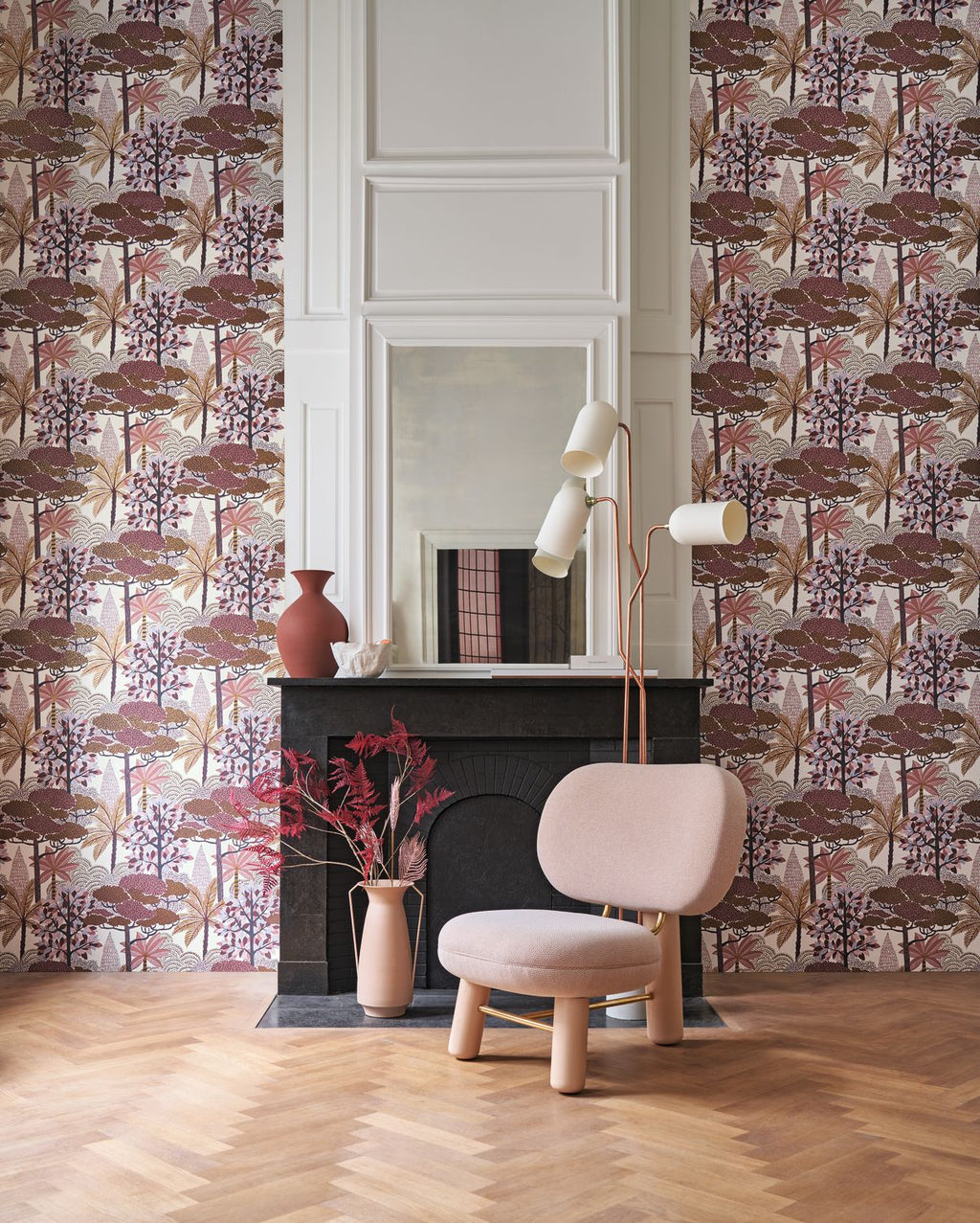 Marakanda wallpaper by Casamance in rosewood and cream, a blossoming tree design styled beside a fireplace with a pink armchair
