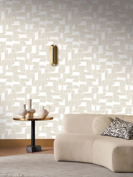 Hector wallpaper by Casamance in cream and ivory, styled behind a boucle sofa with brass sconce and round table