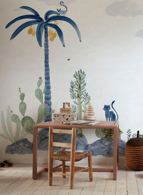 Wilton wall mural by Sandberg in blue, styled in a nursery behind a terracotta kids desk and timber chair