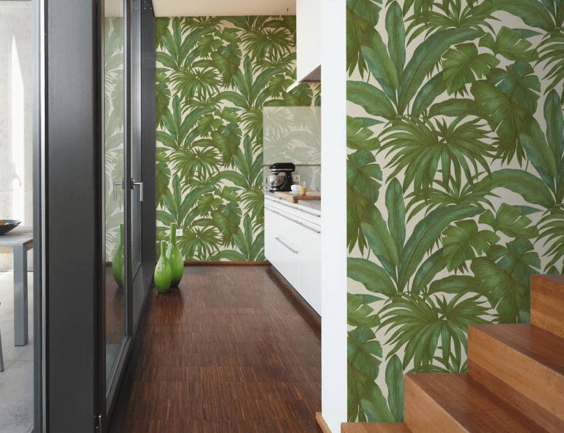 Versace tropical palm wallpaper features large scale hand painted green tropical palm leaves on a white background. 