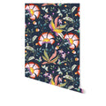 Spring Has Sprung wallpaper by Wallpaper Trader in navy, colourful florals on a deep blue ground, shown as a hanging roll