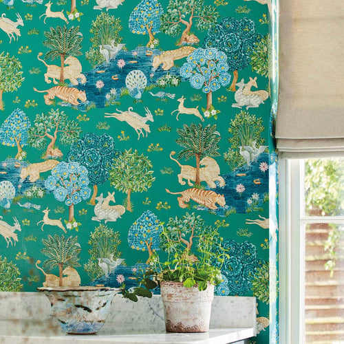 Pamir Garden Teal wallpaper by Sanderson with lions, tigers, deer and peacocks among trees, styled above a marble bench with